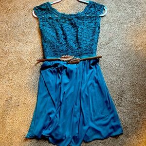 Sleeveless dress with a Lacey top, flowy skirt, has a inner liner and supports